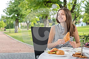 Brunch Choice Dining Food Options Eating Concept. Couple having a brunch with sparkling wine outdoors.