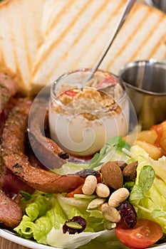 Brunch with german sausage, cereal, French fries and toast