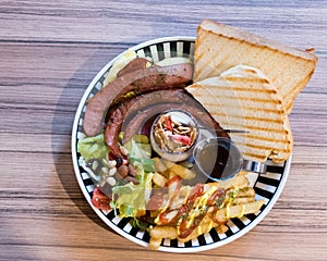 Brunch with german sausage, cereal, French fries and toast