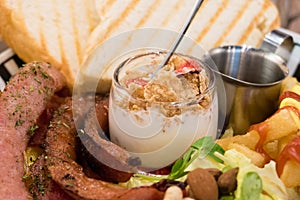 Brunch with german sausage, cereal, French fries and toast