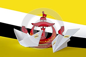 Brunei Darussalam flag depicted on paper origami airplane and boat. Handmade arts concept