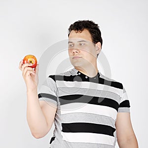 Brunet man holds apple