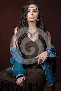 Brunet model with necklace earrings in fashionable jewelry