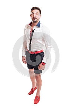 Brunet model wearing black short pants, white shirt and red belt