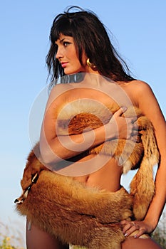 Brunet nude woman in fur.