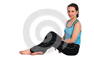 Brunet sport girl sits on floor posing