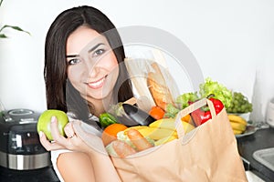 Brunet woman holding paper bag with vegetarian food