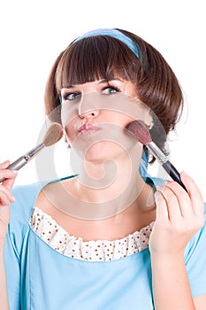 Brunet woman with two make-up brushes