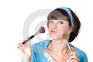 Brunet woman with two make-up brushes