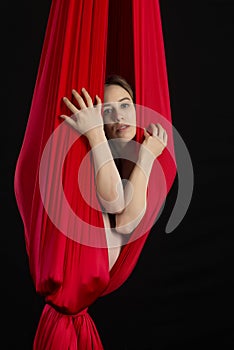 Brunette acrobat in red silk