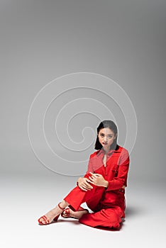 brunette asian model in red jacket