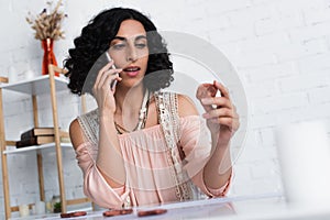 brunette astrologist talking on smartphone and photo