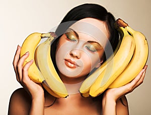 Brunette with bananas on a white background