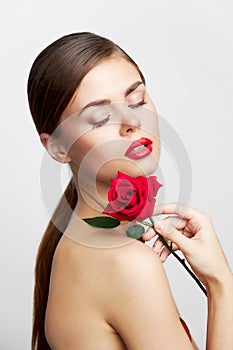 Brunette with bare shoulders Eyes closed flower charm red lips