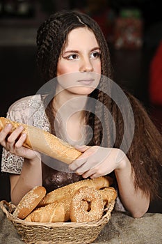 Brunette with a basket with rolls and bagels