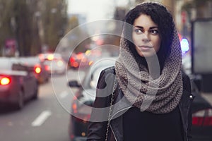Brunette beautiful caucasian woman in scarf on a european city s