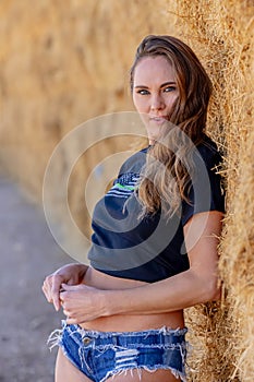 Brunette Beauty in Golden Fields: A Captivating Pose Under Azure Skies