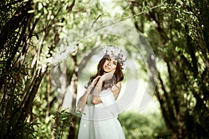 Brunette bride in fashion white wedding dress with makeup