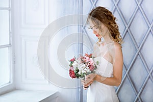 Brunette bride in fashion white wedding dress with makeup