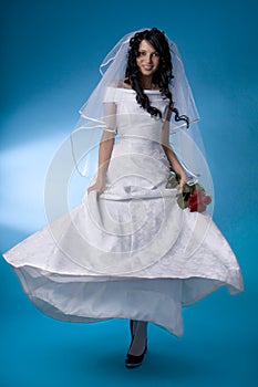 Brunette bride with red roses
