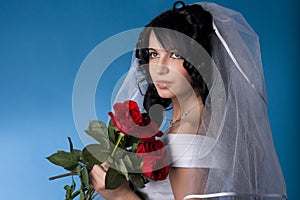 Brunette bride with red roses