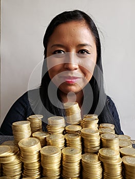brunette business woman and stacked mexican coins