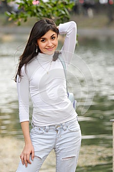 Brunette in casual at pond