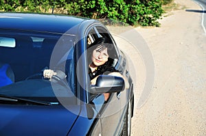 Brunette driving a car