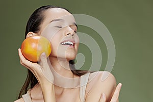 brunette eating grapefruit in hands smile vitamins diet  background