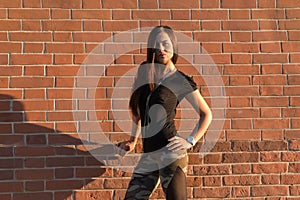 Brunette elegant woman in front of brick wall backround