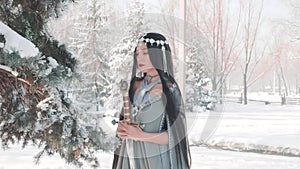 Brunette elf warrior with black long hair prays before starting bloody battle, mentally asks forgiveness from spirit of