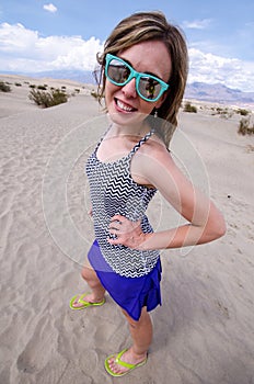 Brunette female wearing beach sunglasses at the Mesquite Sand Dunes in Death Valley National Park California