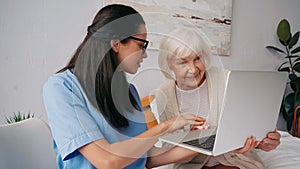 brunette geriatric nurse showing happy aged