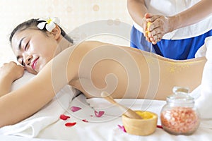 Brunette Getting a Salt Scrub Beauty Treatment in the Health Spa. Body Scrub