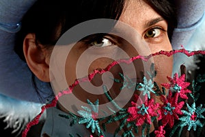 Brunette girl with cowboy hat and spanish fan