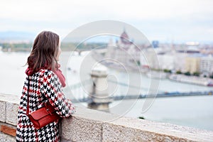 Brunette girl is enjoying view of Hungarian Parliament in Budapest