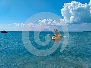 Brunette girl kayaking through lover`s key kayak trail