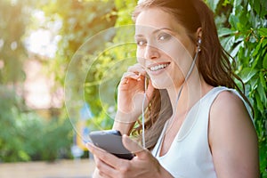 Brunette girl listening to music or audio book with headphones