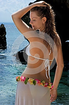 Brunette girl with long hair at the sea