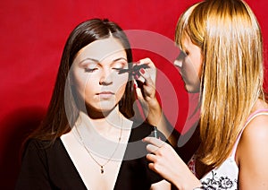 Brunette girl model, while make-up before shooting session
