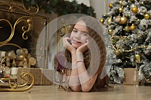 Brunette girl near the christmas tree