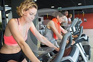 Brunette girl and other females working out in sport club