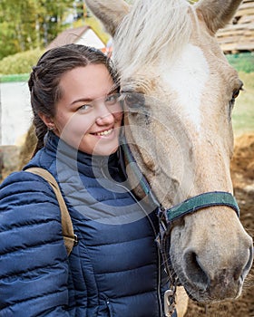 Brunette girl with palomino horse