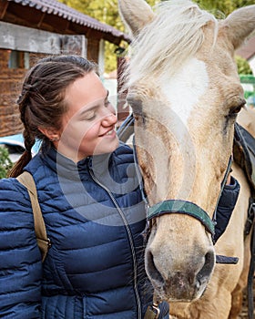 Brunette girl with palomino horse