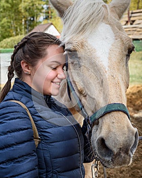 Brunette girl with palomino horse