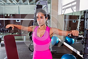 Brunette girl plate raise flies fly workout at gym