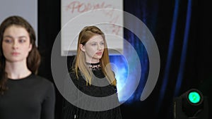 Brunette girl on podium catwalk during fashion show week. Vogue runway defile.