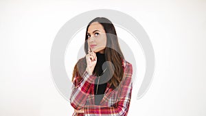 brunette girl pondering over something, medium closeup isolated studio shot