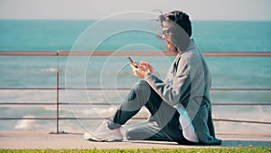 Brunette girl reading or writing sms on her mobile smartphone.