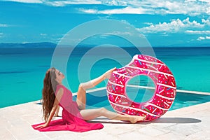 brunette Girl relaxing with inflatable float ring by the ho